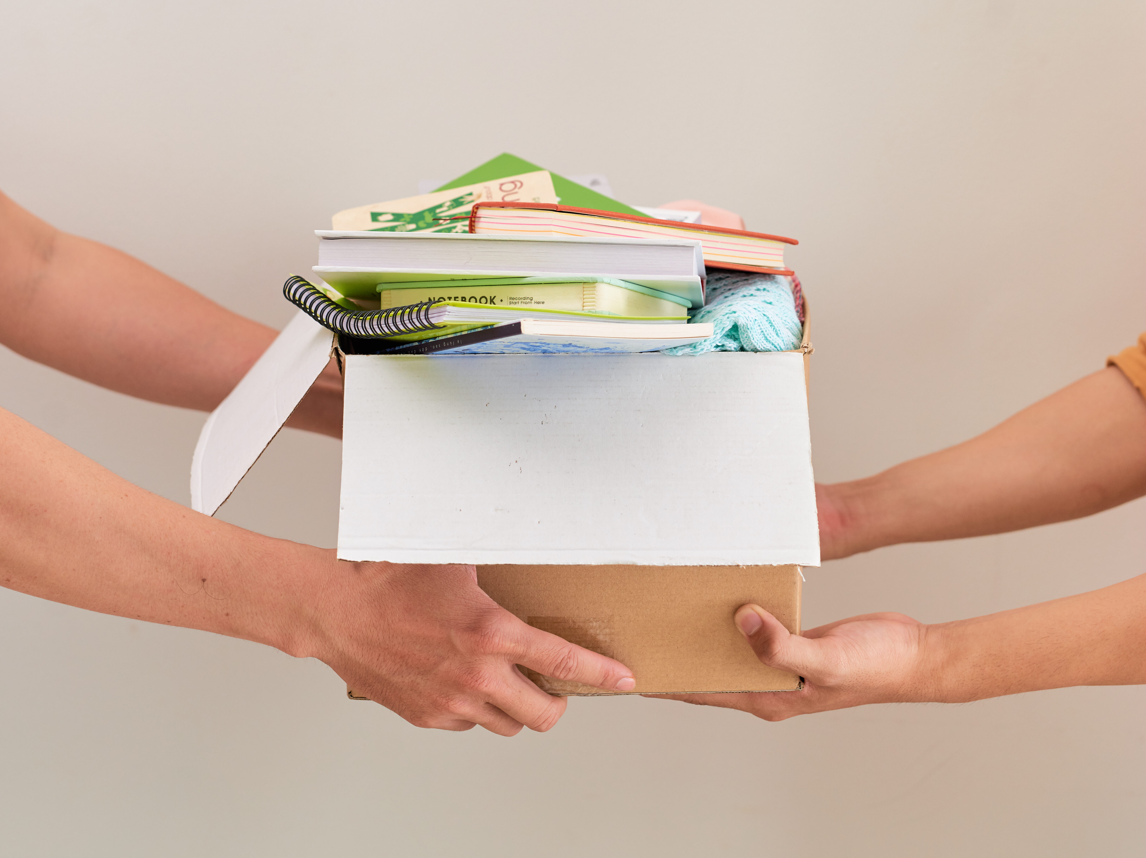 Man Donating Unwanted Items To Charity Shop